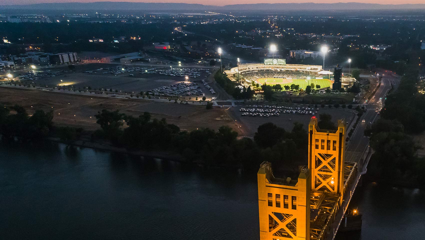drone shot of bridge and baseball stadium in Sacramento